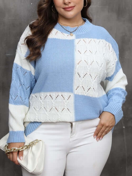 Plus size openwork color block long sleeve sweater in light blue and white worn by woman holding a white clutch.